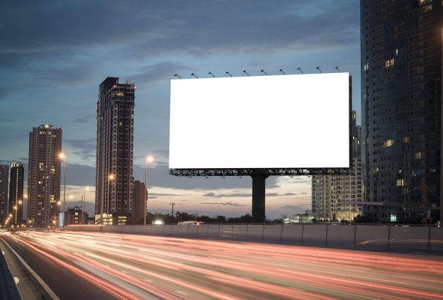 blank billboard on the highway blank billboard during the twilight light blank billboard in city background. With clipping path on screen.- can be used for display your products or promotional