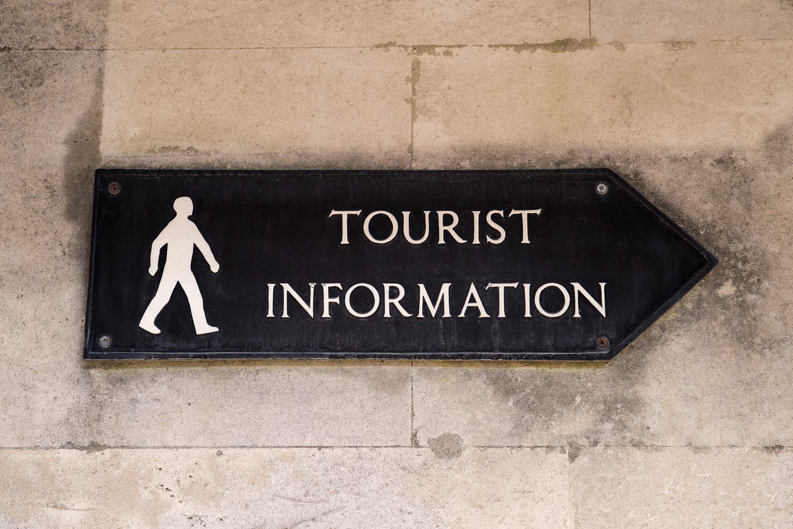 A Sign Showing The Direction To A Tourist Information.