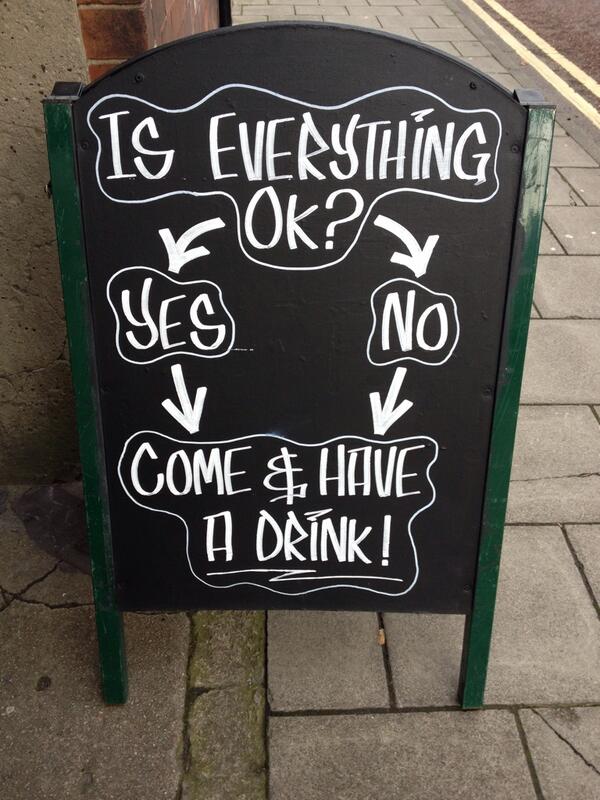 Outdoor bar sign telling customers to have a drink