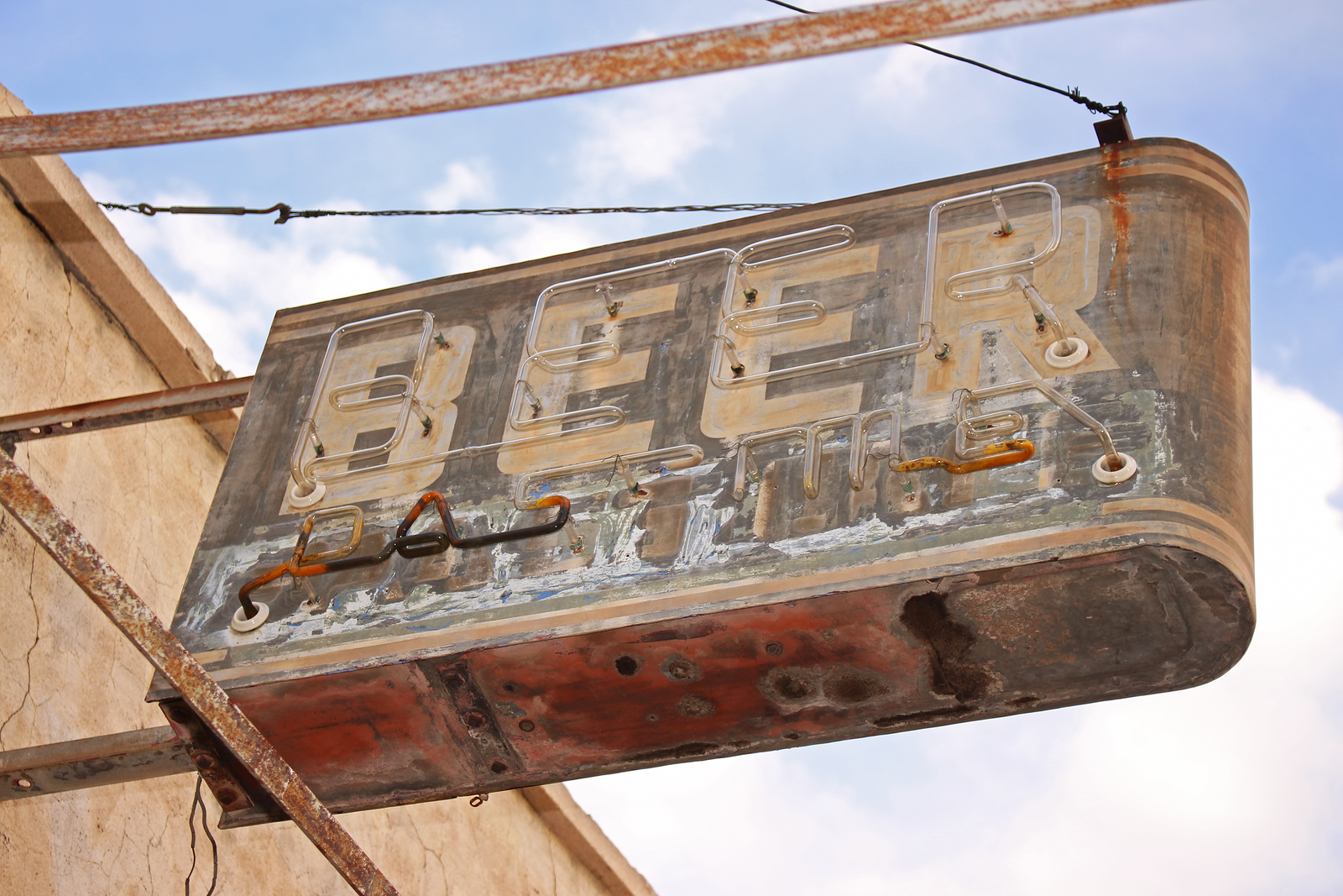 bigstock–182809423 A beer sign marks the location of a long abandoned bar in the American Southwest.