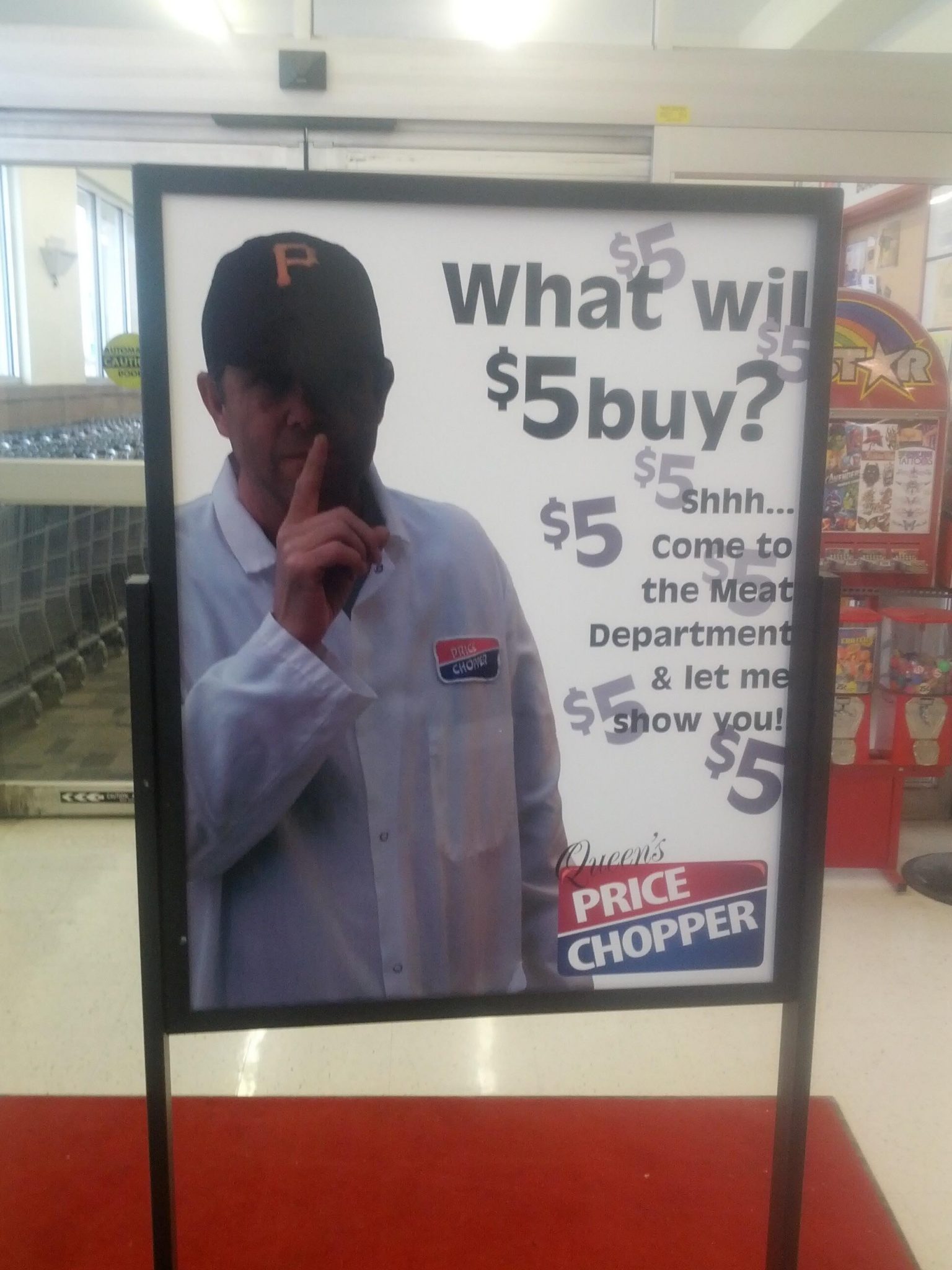 Sign in grocery store with man whispering. it says, "find out what $5 can buy"