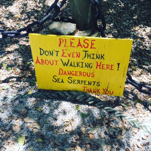 Don't Even Think Sign that warns about sea serpents