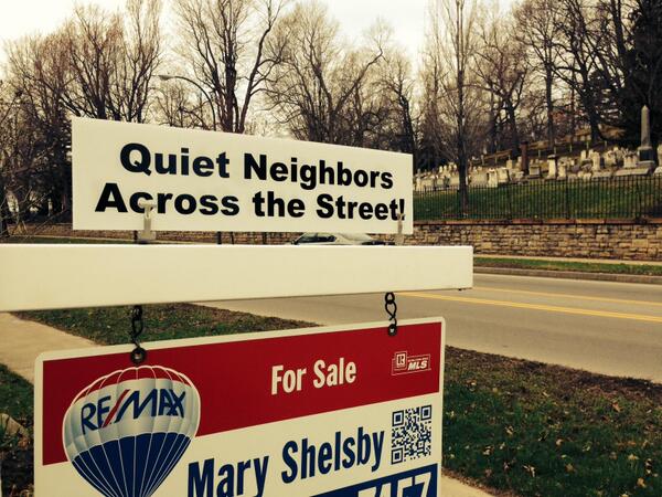 Quiet Neighnbors For sale sign next to cemetery that says "quiet neighbors across the street"