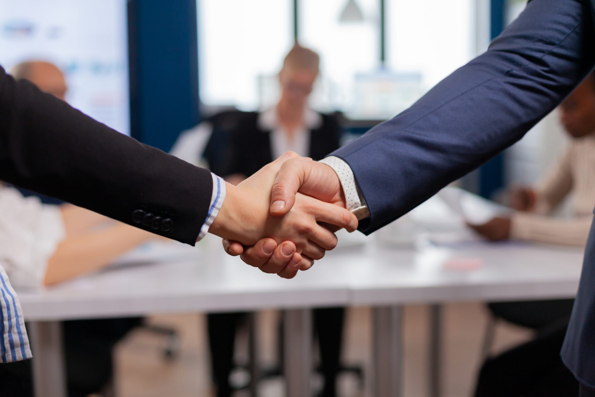 Satisfied businessman company employer wearing suit handshake new employee Business owner agrees to work with professional signage company