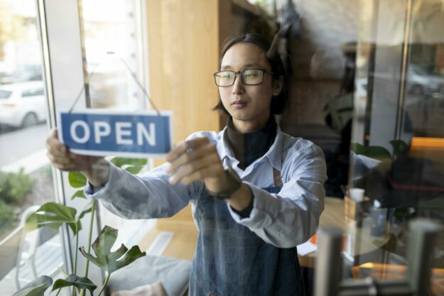 medium-shot-man-with-open-sign Opening a new business this year? Here's what to know about signage!