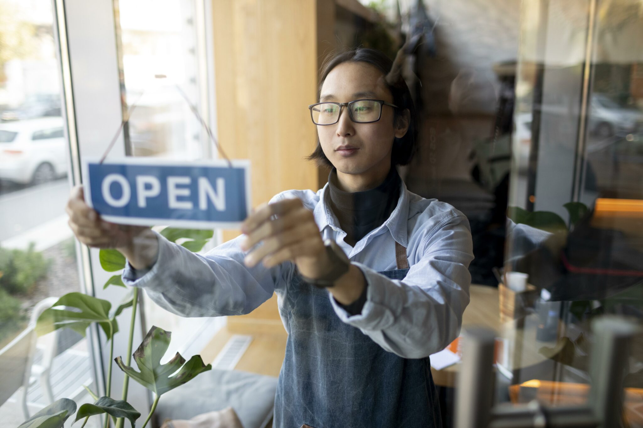 medium-shot-man-with-open-sign Opening a new business this year? Here's what to know about signage!