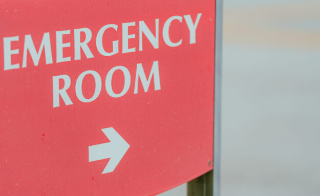 Red EMERGENCY ROOM sign in a hospital